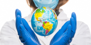 dentist holding up a globe